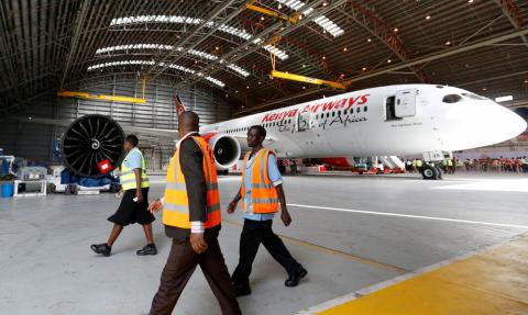 Workers walk past a Kenya Airways Boeing Dreamliner 787-8 inside a hangar at the carrier's headquarters in Nairobi, Kenya, June 27, 2018. PHOTO BY REUTERS/Thomas Mukoya