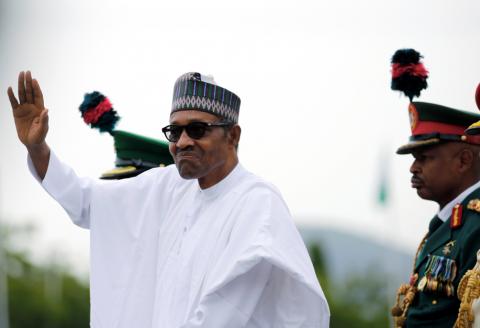 Nigerian President Muhammadu Buhari waves at the crowd while he drives around the venue during his inauguration for a second term in Abuja, Nigeria, May 29, 2019. PHOTO BY REUTERS/Afolabi Sotunde