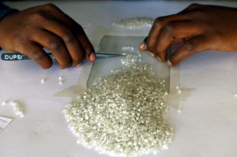 A worker at the Botswana Diamond Valuing Company displays a rough diamond during the sorting process at the purpose-built centre in the capital Gaborone. PHOTO BY REUTERS