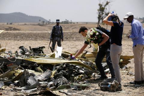 An American family lays flowers for their daughter, who died in the Ethiopian Airlines Flight ET 302 plane crash, after a commemoration ceremony at the scene of the crash, near the town of Bishoftu, southeast of Addis Ababa, Ethiopia, March 13, 2019. PHOTO BY REUTERS/Baz Ratner