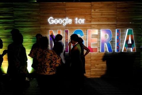 Participants walk past glowing signs during a conference tagged 'Google for Nigeria' in Nigeria's commercial capital Lagos, July 27, 2017. PHOTO BY REUTERS/Akintunde Akinleye