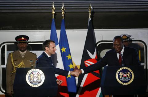 French President Emmanuel Macron greets Kenya's President Uhuru Kenyatta as they address a news conference after touring the Nairobi Central Railway in Nairobi, Kenya, March 13, 2019. PHOTO BY REUTERS/Thomas Mukoya