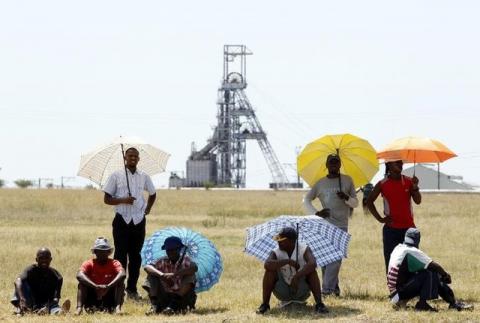 Miners outside the Impala platinum mine in Rustenburg, 120 km (75 miles) northwest of Johannesburg. PHOTO BY REUTERS/Siphiwe Sibeko