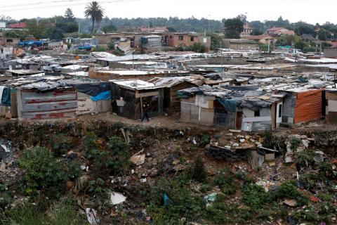 A man walks between shacks in Alexandra township, Johannesburg, South Africa, April 10, 2019. PHOTO BY REUTERS/Siphiwe Sibeko