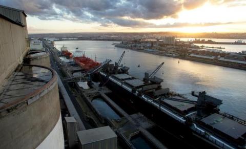 Grain is loaded aboard ships for export in Durban, South Africa, May, 2004. PHOTO BY REUTERS/Mike Hutchings