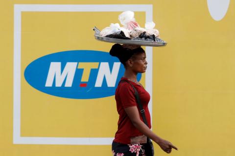 A woman walks past an advertising posters for MTN telecommunication company along a street in Lagos, Nigeria, August 28, 2019. PHOTO BY REUTERS/Temilade Adelaja