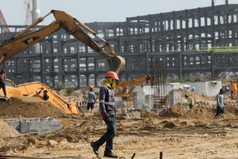 A worker walks past excavators at a construction site of the Dangote refinery in Ibeju Lekki district, on the outskirts of Lagos, Nigeria, August 7, 2019. PHOTO BY REUTERS/Temilade Adelaja