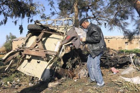 A man looks at the scene near a military base in Barsis, some 50 km (30 miles) outside Benghazi, after a suicide bomber detonated a truck packed with explosives at an army checkpoint