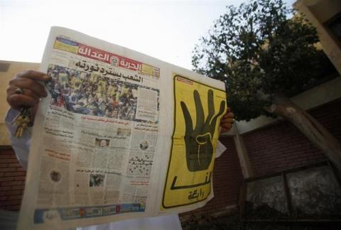 A man reads the Muslim Brotherhood's newspaper Al-Hurriya wa-l-adala