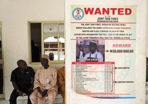 A poster advertising for the search of Boko Haram leader Abubakar Shekau is pasted on a wall in Baga village