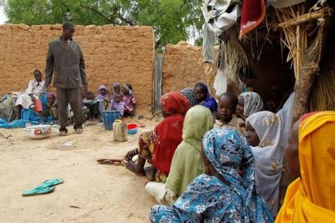 Aba Ali, a Nigerian refugee who fled from his village in northeastern Nigeria into Niger following Boko Haram attacks, stands next to his relatives at the home of Adamu Moumouni, his Nigerien host who took them in, in Diffa in southeastern Niger, June 21, 2016. PHOTO BY REUTERS/Luc Gnago