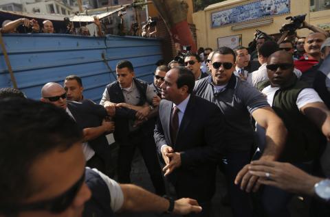 Presidential candidate and former army chief Abdel Fattah al-Sisi (C) arrives with his bodyguards at a polling station to cast his vote during the presidential election in Cairo