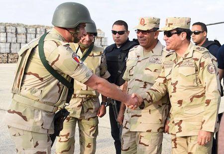 Egyptian President Abdel Fattah al-Sisi (R) greets members of the Egyptian armed forces, after travelling to the troubled northern part of the Sinai peninsula to inspect troops, in this July 4, 2015. PHOTO BY REUTERS/The Egyptian Presidency