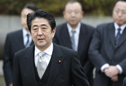 Japan's Prime Minister Shinzo Abe arrives at the controversial Yasukuni Shrine to pay tribute to the war dead, in Tokyo