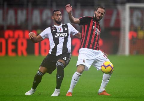 AC Milan's Gonzalo Higuain in action with Juventus' Medhi Benatia. PHOTO BY REUTERS/Alberto Lingria