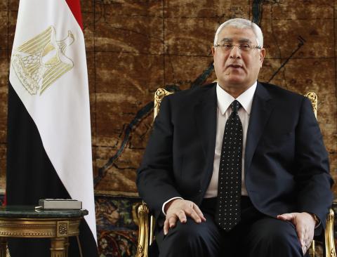 Egypt's new prime minister Adly Mansour attends a meeting El-Thadiya presidential palace in Cairo