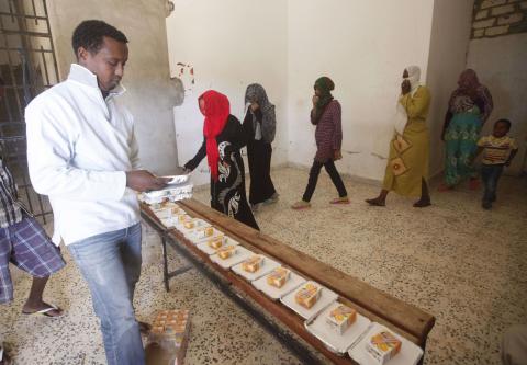 African migrants take food at a detention center in Sorman, 55 km (34 miles) west of Tripoli, Libya