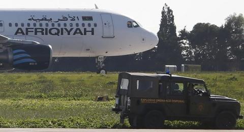 A Maltese military vehicle stands near a Libyan Afriqiyah Airways Airbus A320 on the runway at Malta Airport, December 23, 2016. PHOTO BY REUTERS/Darrin Zamit-Lupi