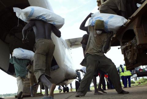 Workers load food onto a UN World Food Programme (WFP) plane for air dropping in Olilim camp in Lira district. PHOTO BY REUTERS/James Akena