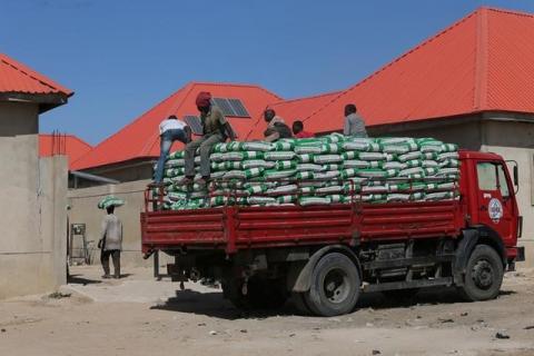 Workers are seen offloading food from a truck at the Bakkasi Internally displaced peoples' camp Maiduguri, Nigeria, November 30, 2016. PHOTO BY REUTERS/Afolabi Sotunde