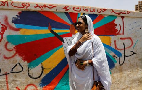 Alaa Salah, a Sudanese protester whose video gone viral and make her an icon for the mass anti-government protests, stands in front of a mural depicting her in front of the Defence Ministry in Khartoum, Sudan, April 20, 2019. PHOTO BY REUTERS/Umit Bektas