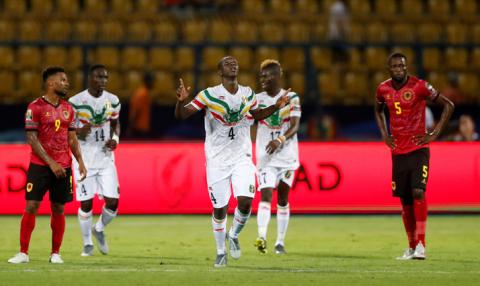 Mali's Amadou Haidara celebrates scoring their first goal with Mali's Falaye Sacko, Mali's Adama Traore, Angola's Fredy Kulembe and Angola's Dani Massunguna. PHOTO BY REUTERS/Amr Abdallah Dalsh