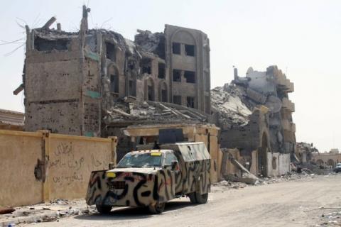 An armoured vehicle is seen near a building that was damaged during a battle between Libyan forces allied with the U.N.-backed government and Islamic State militants in neighborhood Number Three, in Sirte, Libya, October 5, 2016. PHOTO BY REUTERS/Hani Amara