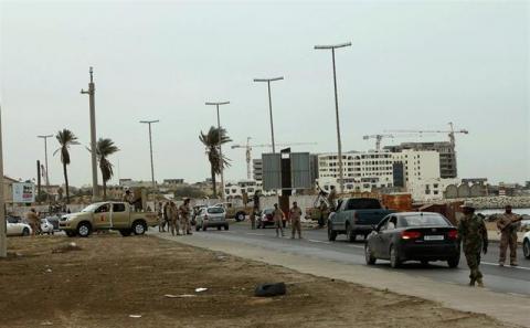 Army personnel man a checkpoint at one of the entrances to Tripoli