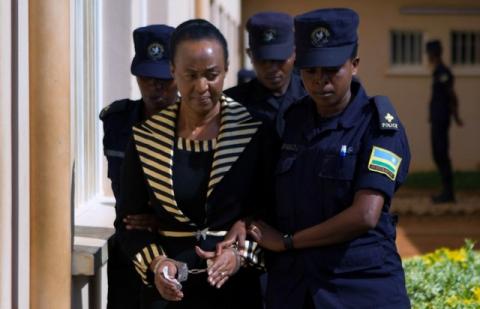 Adeline Rwigara, mother of Diane Shima Rwigara, a prominent critic of Rwanda's President Paul Kagame, is escorted by police officers into a courtroom in Kigali, Rwanda, October 11, 2017. PHOTO BY REUTERS/Jean Bizimana