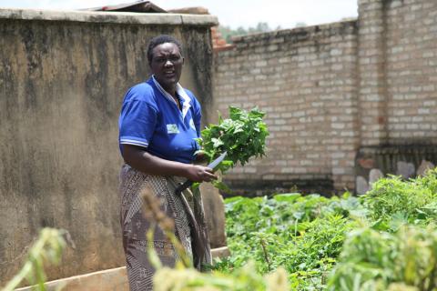 Genocide survivor Assoumpta, 48, stands outside her home in Muhanga district, about 50 km (30 miles) from the Rwandan capital, Kigali on April 7, 2019. PHOTO BY THOMSON REUTERS FOUNDATION/Nita Bhalla