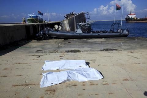 Bags containing a body of two migrants, who died after a boat sank off the coast, lay in a navy base in Tripoli, Libya, December 21, 2015. PHOTO BY REUTERS/Ismail Zitouny