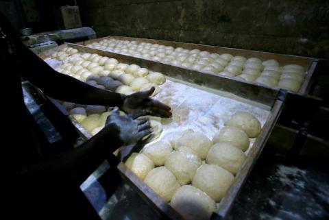 A worker prepares bread dough before baking in a traditional oven at a bakery in Khartoum, Sudan, February 16, 2020. PHOTO BY REUTERS/Mohamed Nureldin Abdallah