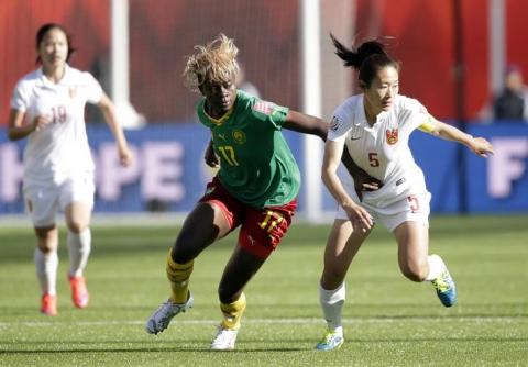 China defender Wu Haiyan (5) and Cameroon forward Gaelle Enganamouit (17) go after the ball during the second half in the round of sixteen in the FIFA 2015 women's World Cup soccer tournament at Commonwealth Stadium. PHOTO BY REUTERS/Erich Schlegel-USA TODAY Sports