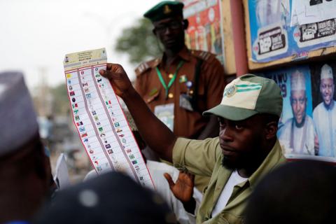 A National Youths Service Corp member counts ballot papers after voting closed at a polling station in Kano State. PHOTO BY REUTERS/Afolabi Sotunde