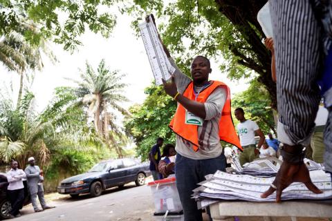 A man raises a ballot paper during the counting of governorship and state assembly election results in Lagos, Nigeria, March 9, 2019. PHOTO BY REUTERS/Adelaja Temilade