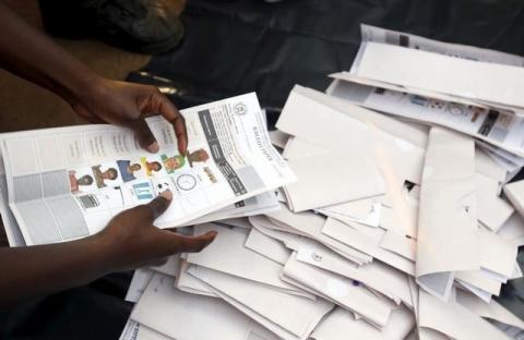 Electoral officials count votes at a polling station in Uganda's capital Kampala February 18, 2016 as voting closes. PHOTO BY REUTERS/James Akena