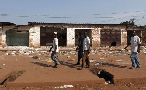 Men walk past looted stores belonging to Muslims in Combattant district in Bangui