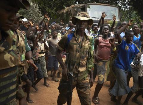 Soldiers of the Multinational Force of Central Africa (FOMAC) watch over a crowd during a religious reconciliation tour in the outskirts of Bangui