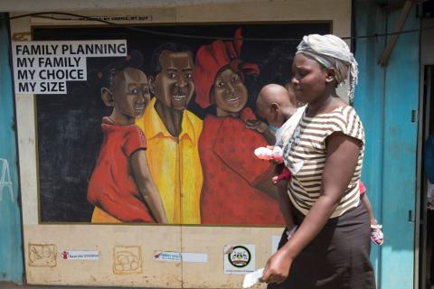 A woman walks past a murel during a visit by The Netherlands Minister for Trade and Development Cooperation Lilianne Ploumen at a Family Health Options clinic in the Kibera slums in Nairobi, Kenya, May 16, 2017. PHOTO BY REUTERS/Baz Ratner