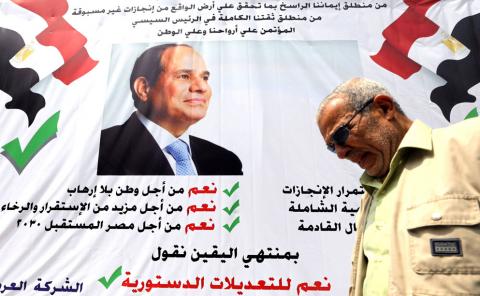 A man walks in front of a banner reading, "Yes to the constitutional amendments, for a better future", with a photo of the Egyptian President Abdel Fattah al-Sisi before the approaching referendum on constitutional amendments in Cairo, Egypt, April 16, 2019. PHOTO BY REUTERS/Mohamed Abd El Ghany