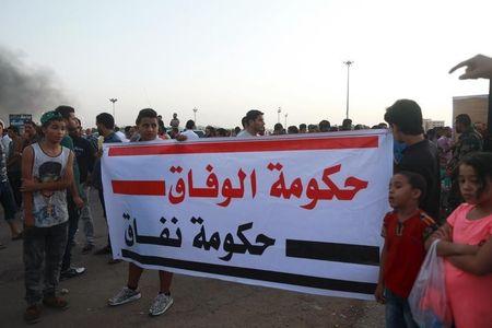 People carry a banner reading "Government Accord Government hypocrisy" during a protest against candidates for a national unity government proposed by U.N. envoy for Libya Bernardino Leon, in Benghazi, Libya, October 9, 2015. PHOTO BY REUTERS/Esam Omran Al-Fetori