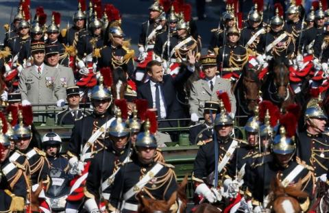 French President Emmanuel Macron and Chief of the Defence Staff French Army General Pierre de Villiers arrive in a command car for the traditional Bastille Day military parade on the Champs-Elysees in Paris, France, July 14, 2017. PHOTO BY REUTERS/Gonzalo Fuentes