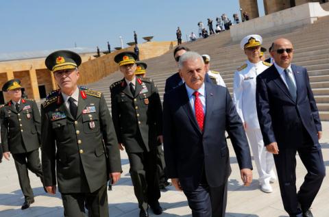 Turkey's Prime Minister Binali Yildirim (C), flanked by Chief of Staff General Hulusi Akar (L), Defense Minister Fikri Isik (R) and the country's top generals, leaves Anitkabir, the mausoleum of modern Turkey's founder Mustafa Kemal Ataturk, after a wreath-laying ceremony ahead of a High Military Council meeting in Ankara, Turkey, July 28, 2016. PHOTO BY REUTERS/Umit Bektas