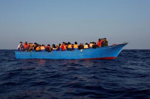 Migrants on board a wooden boat await rescue by the Malta-based NGO Migrant Offshore Aid Station (MOAS) in the central Mediterranean Sea, north of Sabratha, on the Libyan coast, April 5, 2017. PHOTO BY REUTERS/Darrin Zammit Lupi