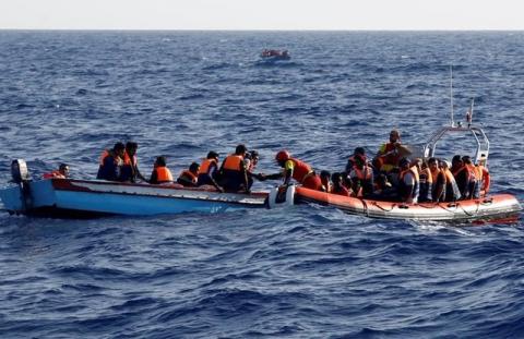 An inflatable boat from the Spanish vessel Astral operated by the NGO Proactiva collects migrants off the Libyan coast in the Mediterranean Sea, August 18, 2016. PHOTO BY REUTERS/Giorgos Moutafis