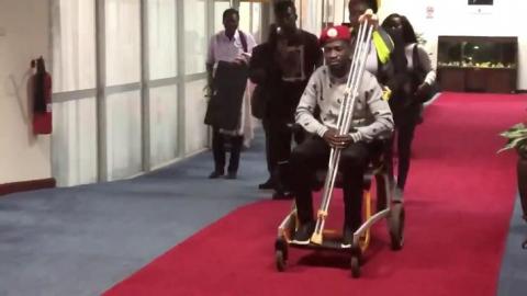 Bobi Wine is seen in a wheelchair just before his departure at Entebbe International Airport, in Entebbe, Uganda, August 31, 2018 in this still image taken from a social media video on September 1, 2018. PHOTO BY REUTERS