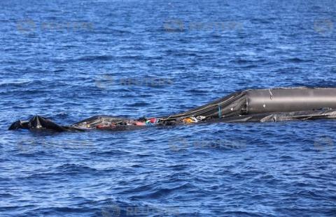 A boat that was carrying immigrants is seen in the Mediterranean Sea off the coast of Libya, March 30, 2018. PHOTO BY REUTERS/Hani Amara