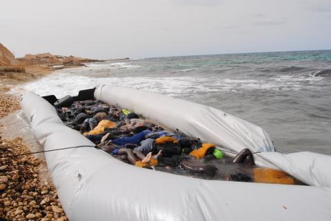 Dead bodies of migrants are seen in an inflatable boat on a beach near the city of Zawiya, Libya, February 20, 2017. PHOTO BY REUTERS/Libyan Red Crescent