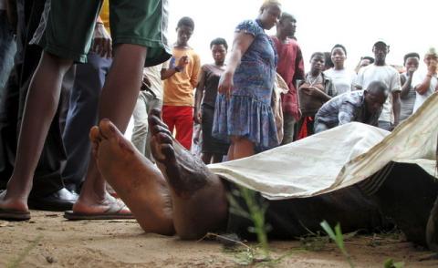 Residents look at the slain bodies of people killed at the Cibitoke district in Burundi's capital Bujumbura, December 9, 2015. PHOTO BY REUTERS/Jean Pierre Aime Harerimana