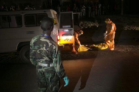 Health workers collect the body of a suspected Ebola victim from a street in the town of Koidu, Kono district in Eastern Sierra Leone, December 18, 2014. PHOTO BY REUTERS/Baz Ratner